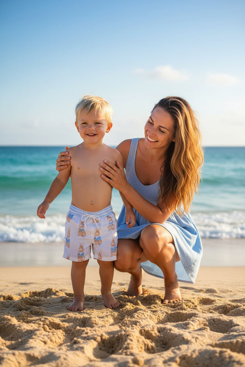 Little Bunny Boys Bunny Print Swim Trunks in White for adorable beach days and pool fun, featuring a playful bunny print swim trunks design.