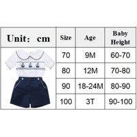 White cotton boys smocked sailboat outfit with navy blue shorts for babies and kids