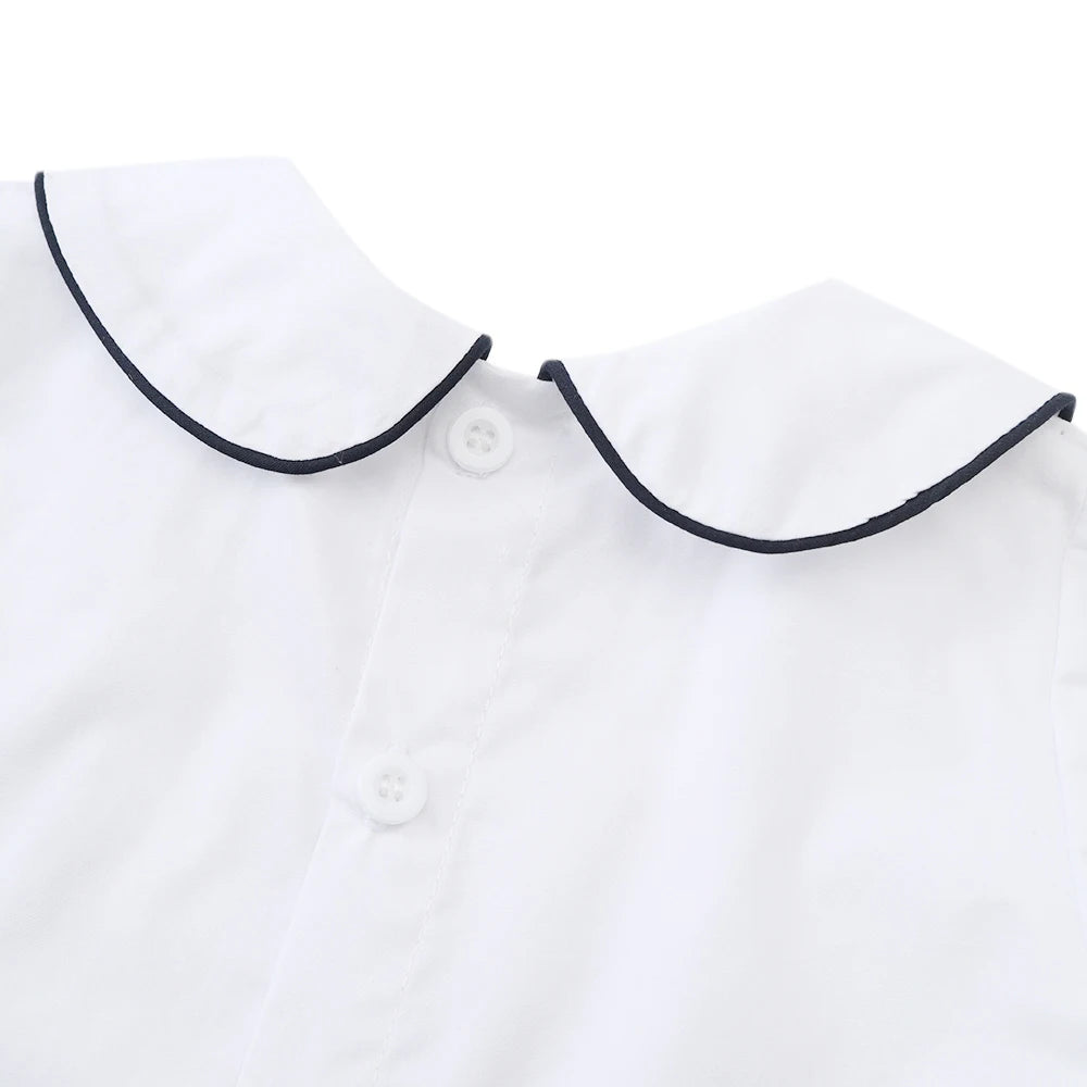 White cotton boys smocked sailboat outfit with navy trim collar and button closure