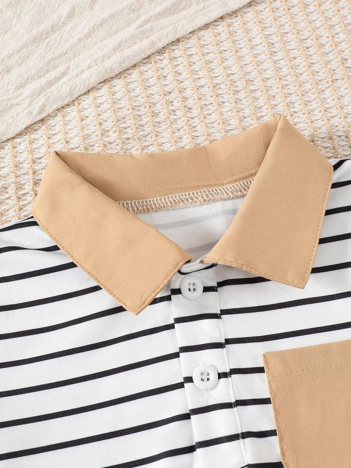 Close-up of boys striped shorts outfit set with beige collar and pocket detail for toddlers
