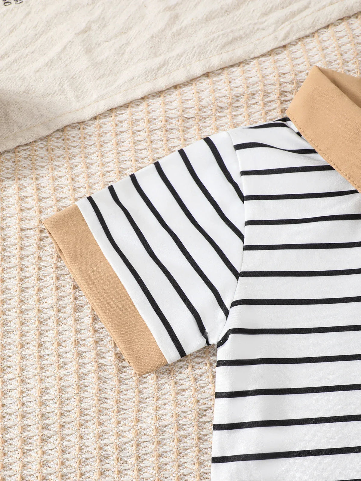 Close-up of boys striped shorts outfit set shirt sleeve with black stripes and tan collar for toddlers