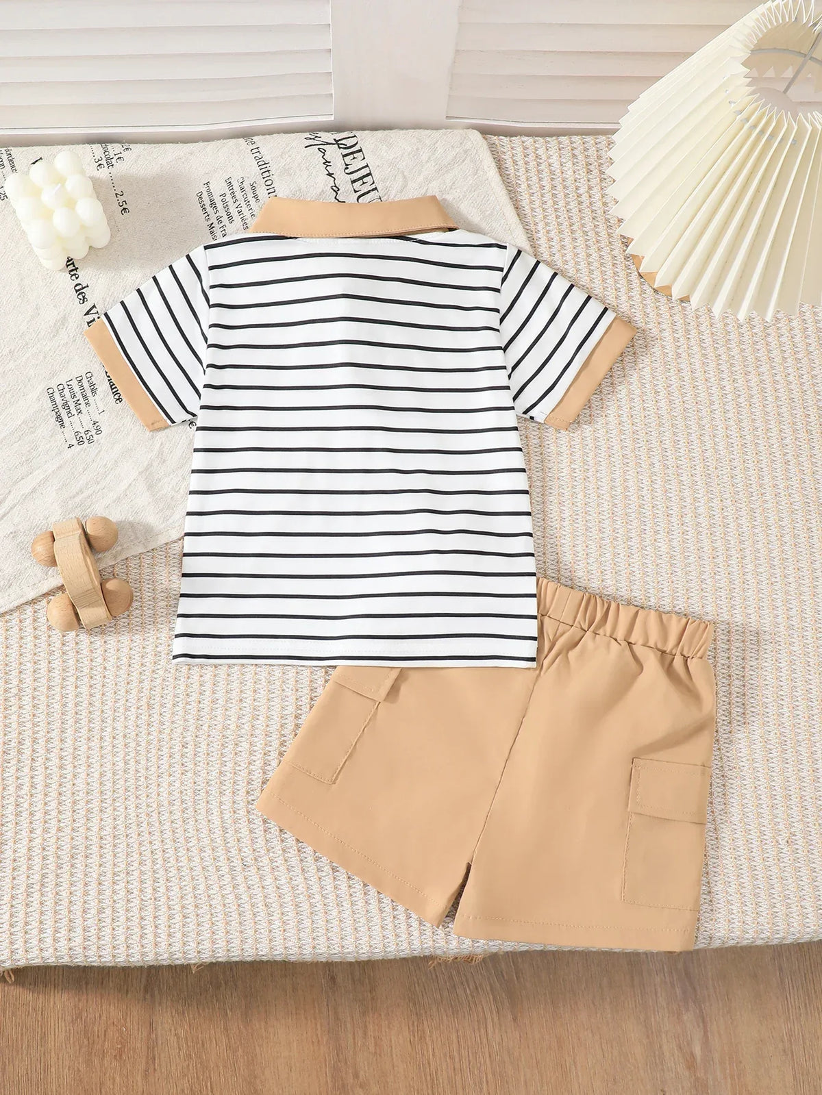 boys striped shorts outfit set with white and black striped shirt and tan shorts for toddlers laid flat