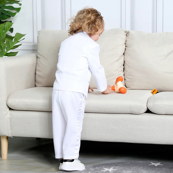 white boys tuxedo set for toddlers with ruffle detail on pants suitable for young children