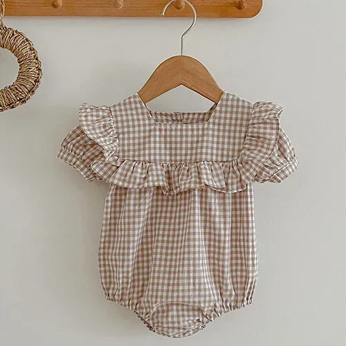 Beige and white gingham bubble romper for babies with ruffle details on sleeves and chest