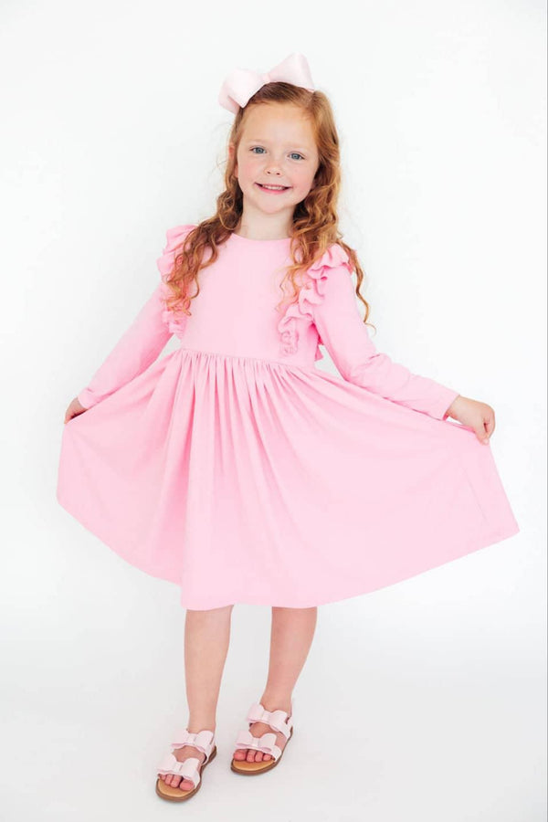 Bubblegum pink girls twirl dress with long sleeves and ruffle details for young children