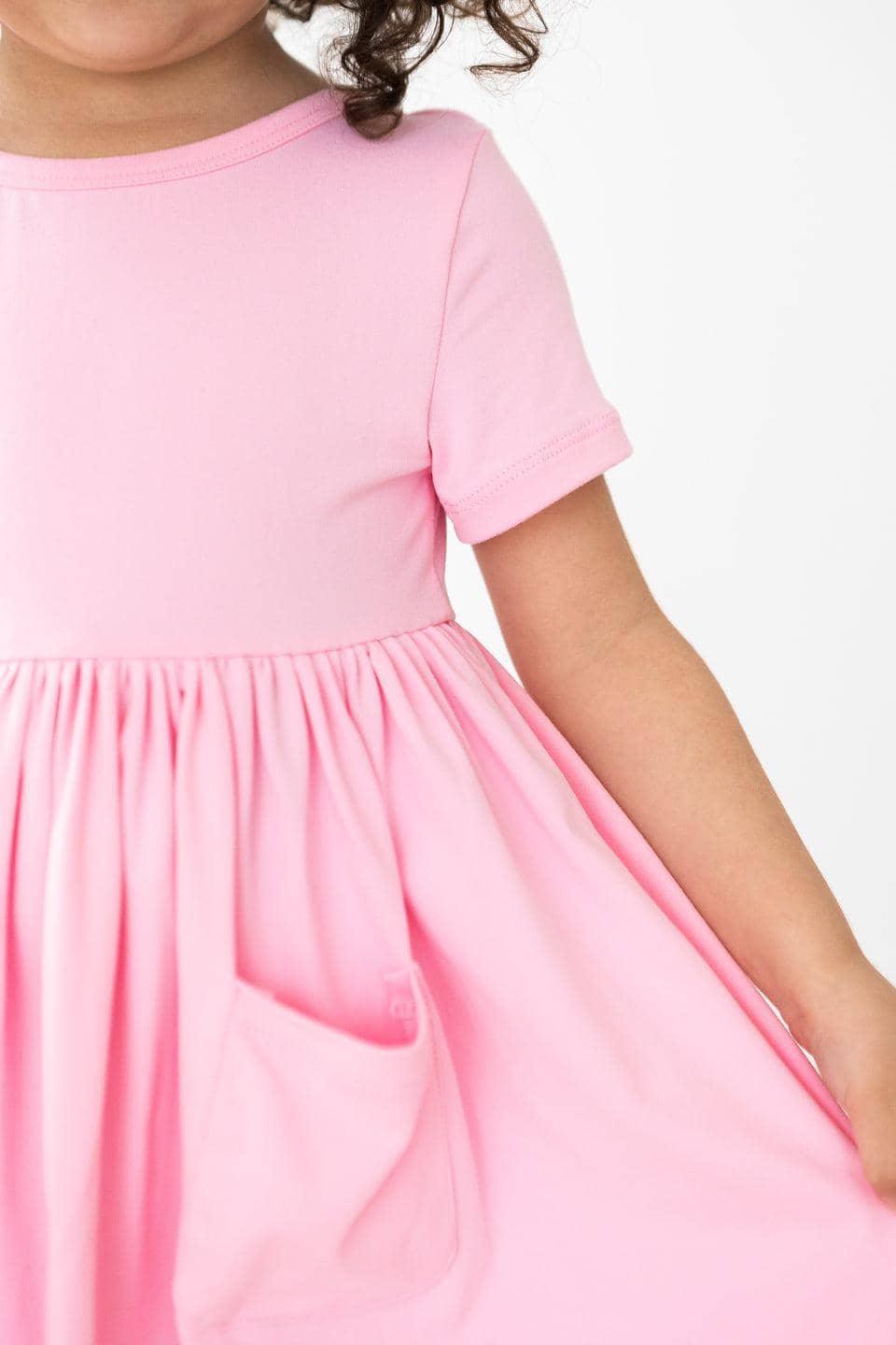 Girls bubblegum pink twirl dress for girls with short sleeves and a pocket detail