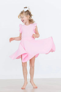 Young girl twirling in a bubblegum pink twirl skort for girls from Mila and Rose