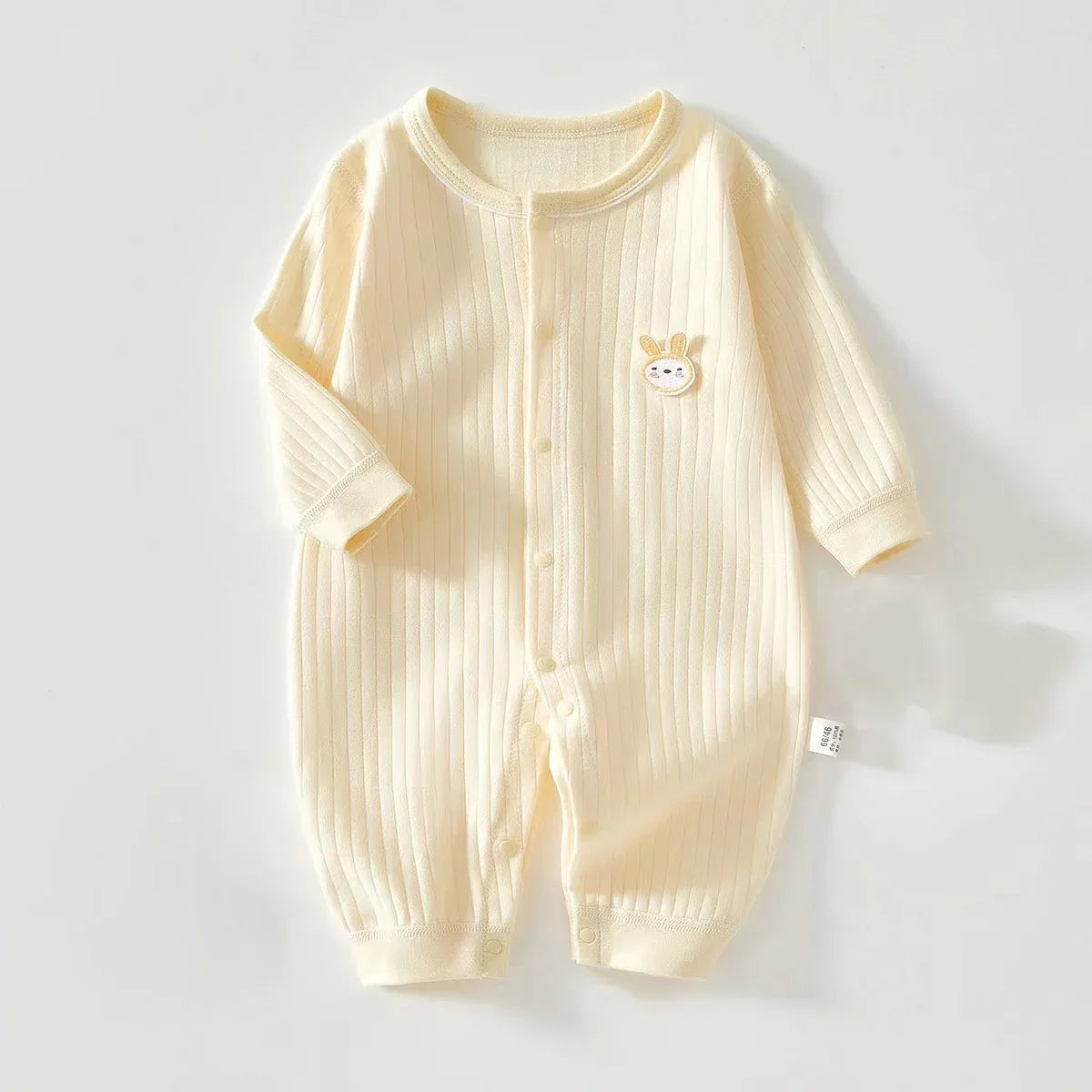 Cream knit bunny baby romper for infants with long sleeves and embroidered bunny detail
