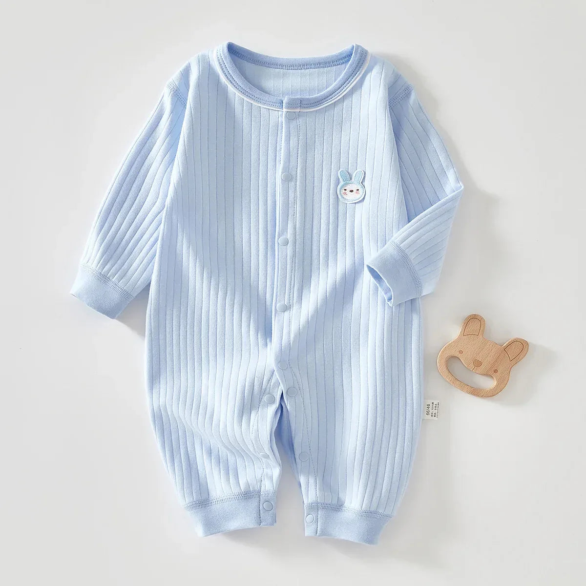 Light blue bunny baby romper for infants with long sleeves and ribbed texture