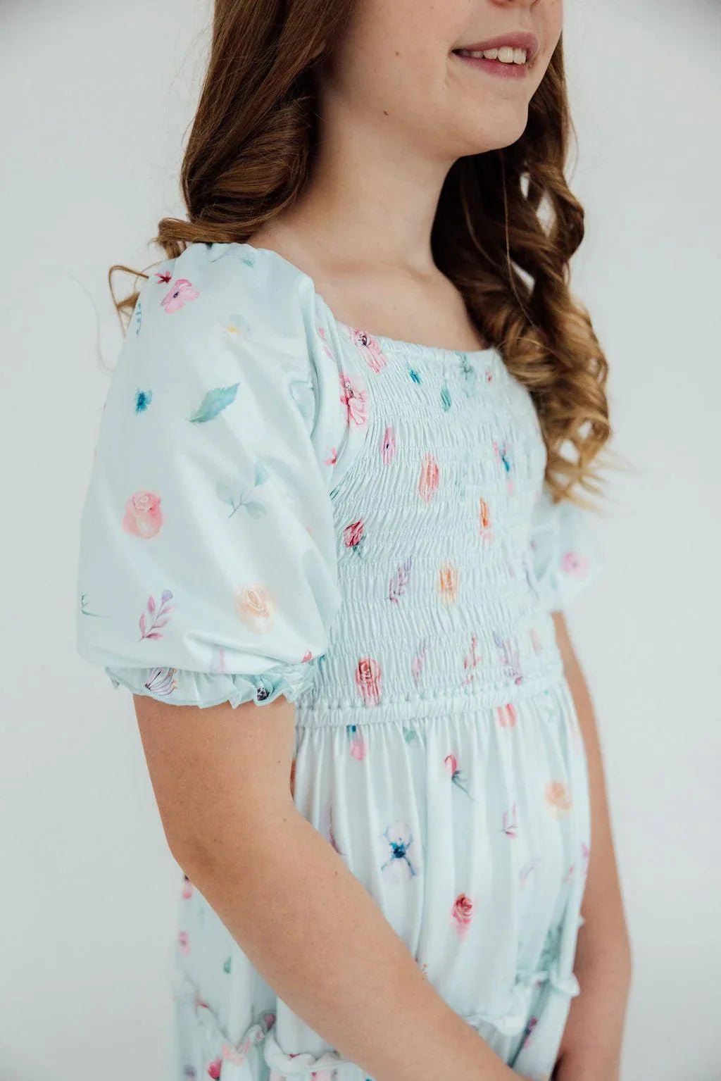 Light blue smocked butterfly dress for girls with ruffle details and puff sleeves