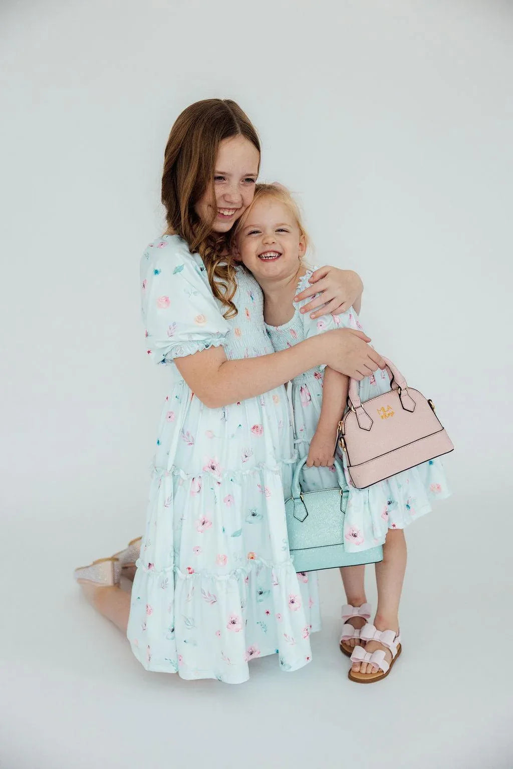 Light blue butterfly dress for girls with smocked bodice and ruffle details in toddler and kids sizes