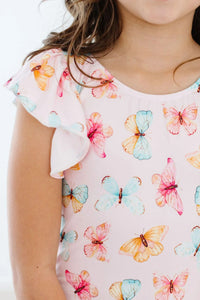 baby wearing pink butterfly flutter sleeve baby leotard with colorful butterflies print