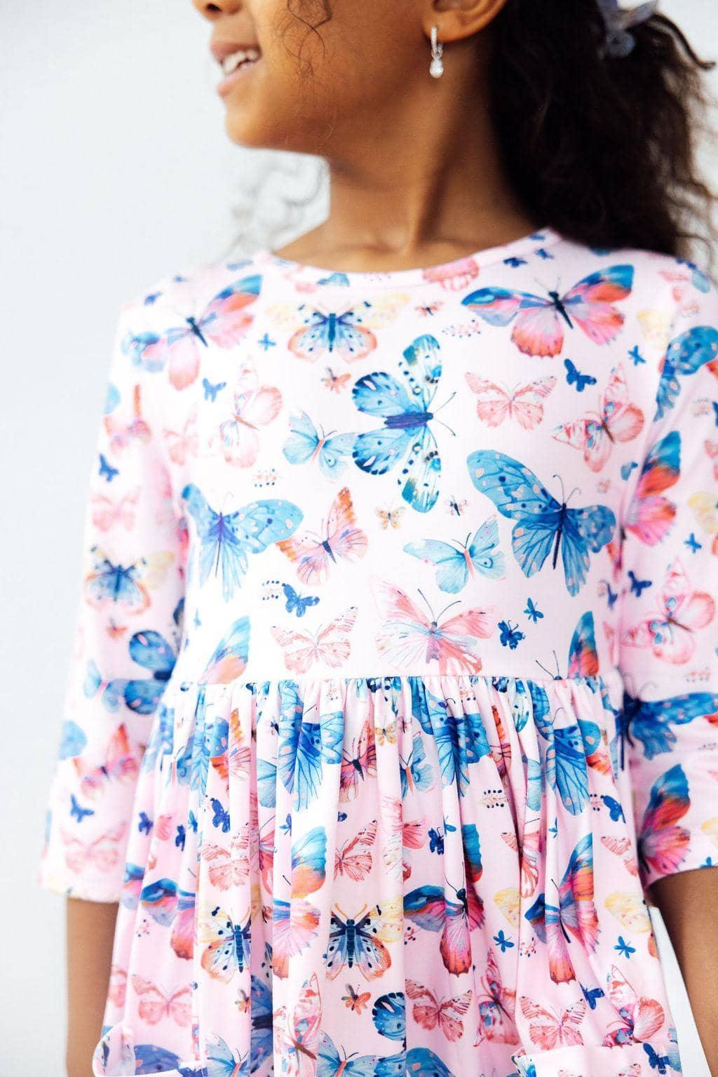 Girls wearing pink butterfly twirl dress for girls with  sleeves twirling happily
