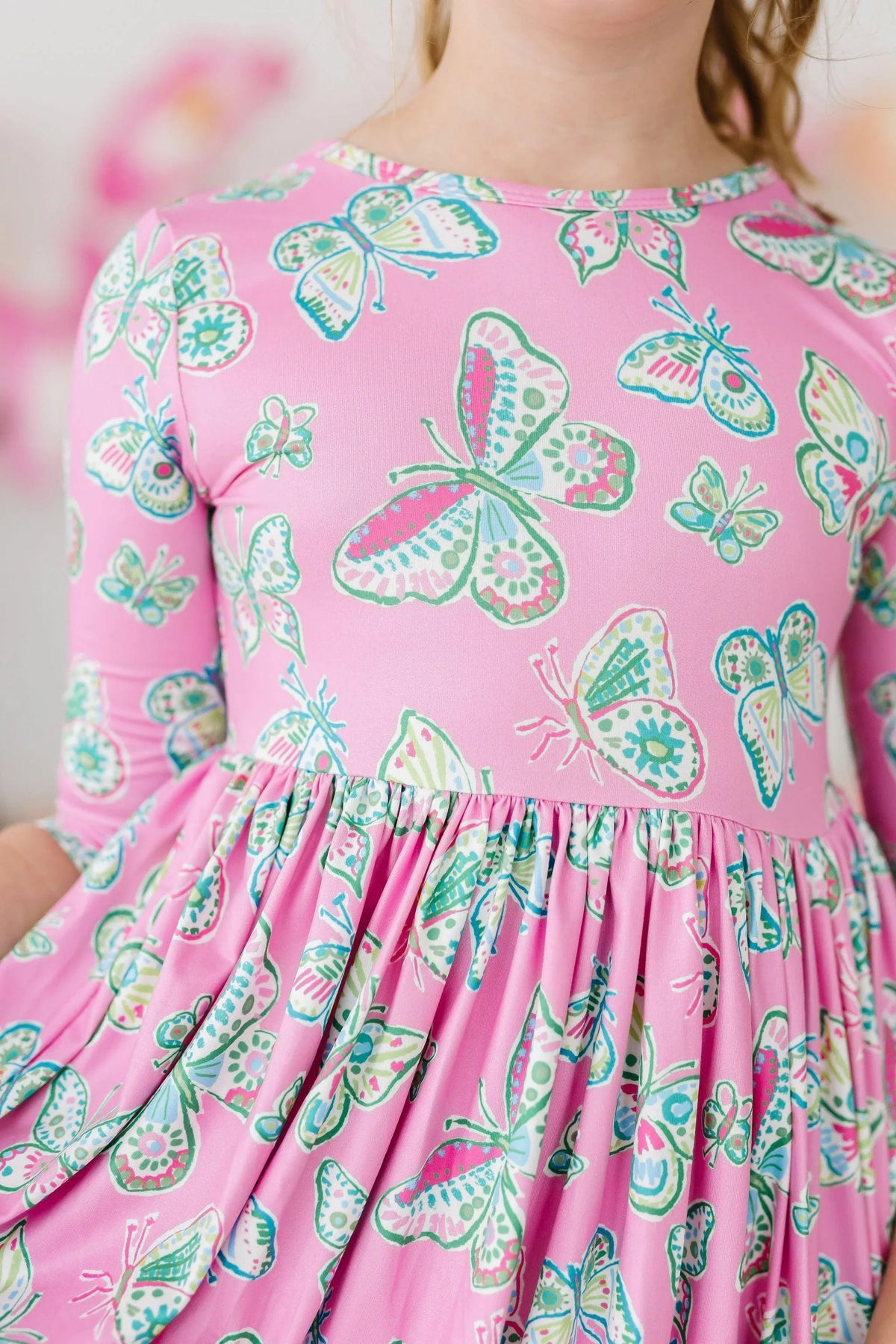 Girls pink butterfly twirl dress for girls by Mila & Rose with 3/4 sleeves and colorful butterfly print