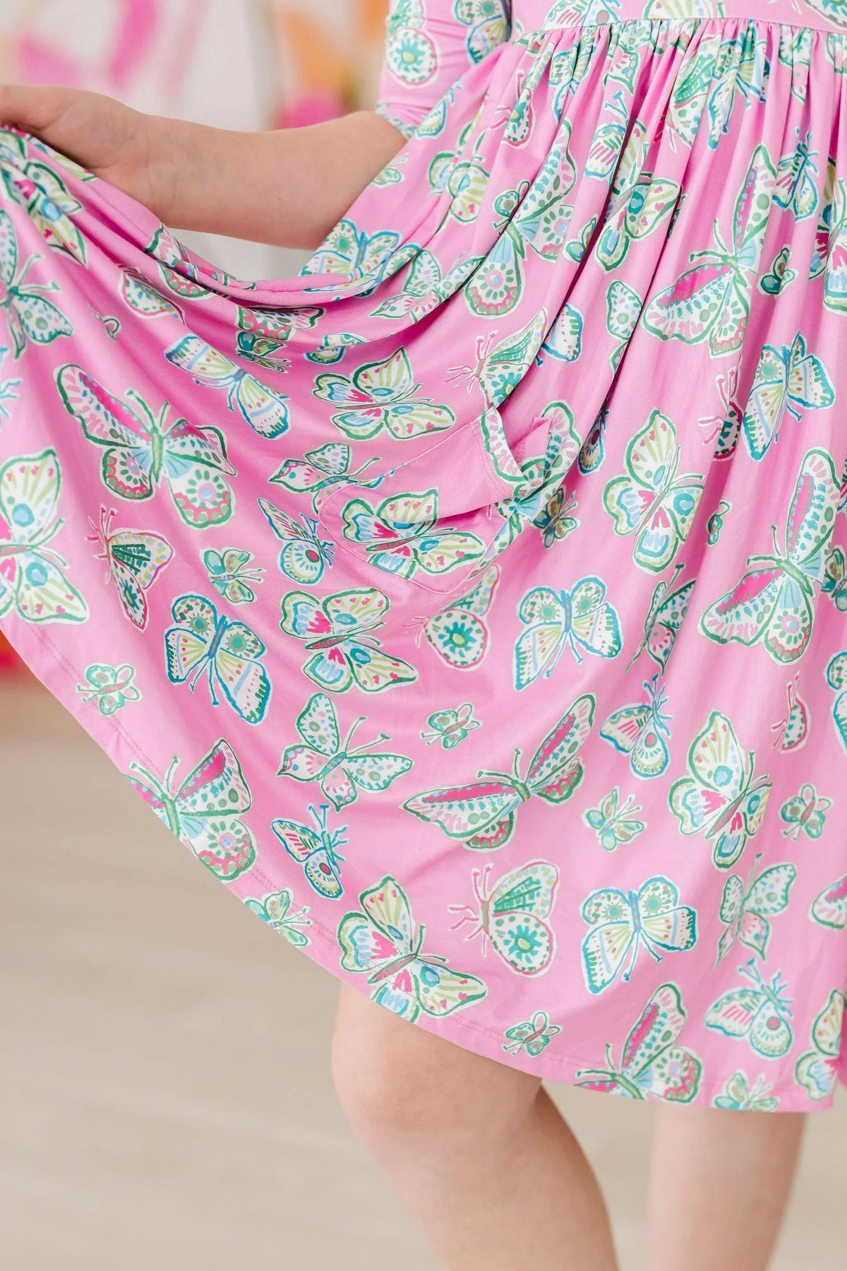 Girls pink butterfly twirl dress for girls with 3/4 sleeves and colorful butterfly print