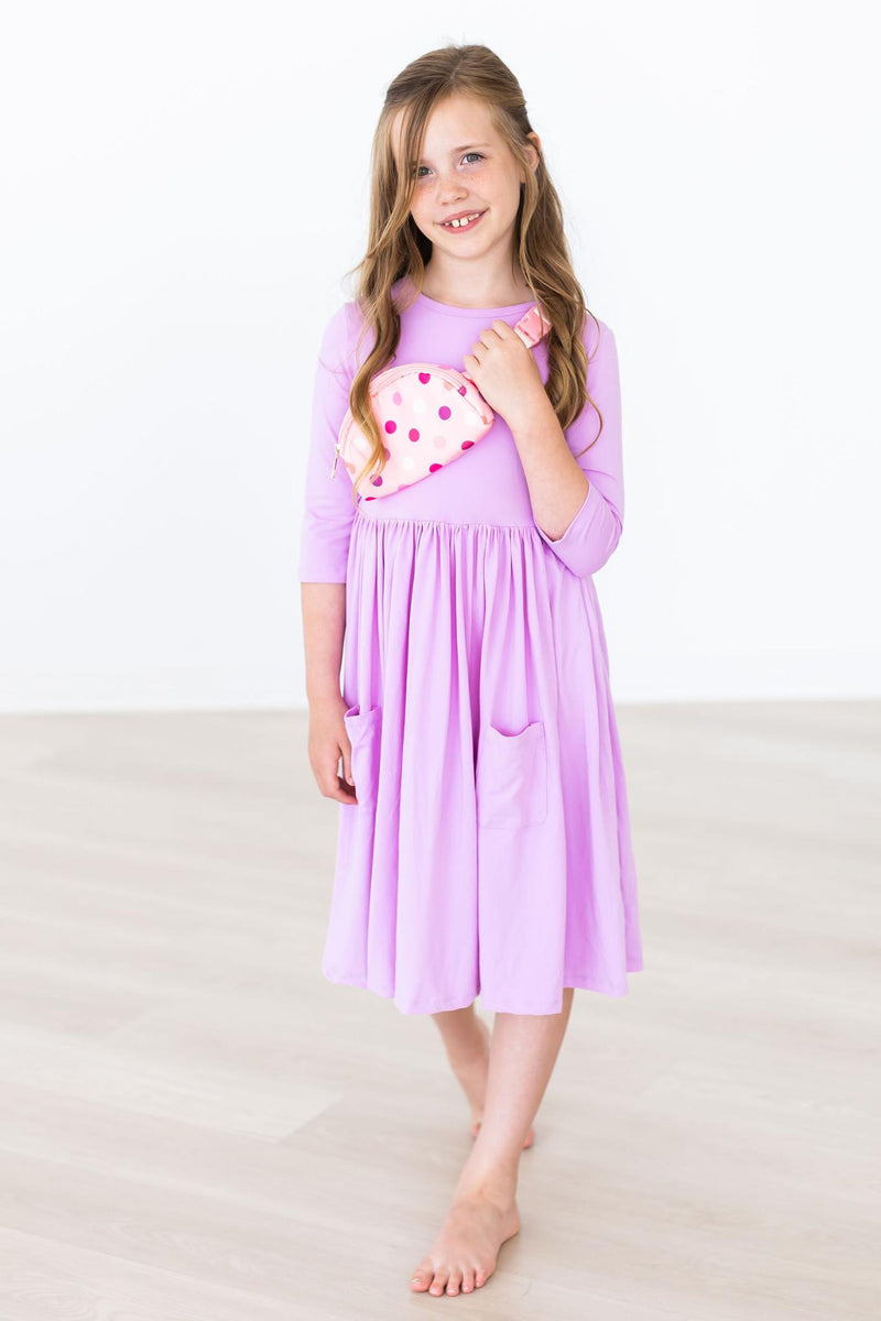 A close-up view of the Bright Lilac 3/4 Sleeve Pocket Twirl Dress for Girls highlighting the soft fabric and convenient pockets.