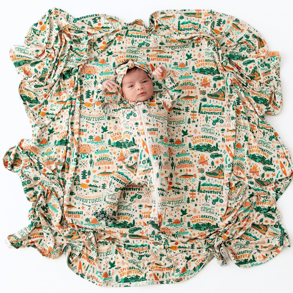 Baby wrapped in a patterned blanket with text and graphics on a white background
