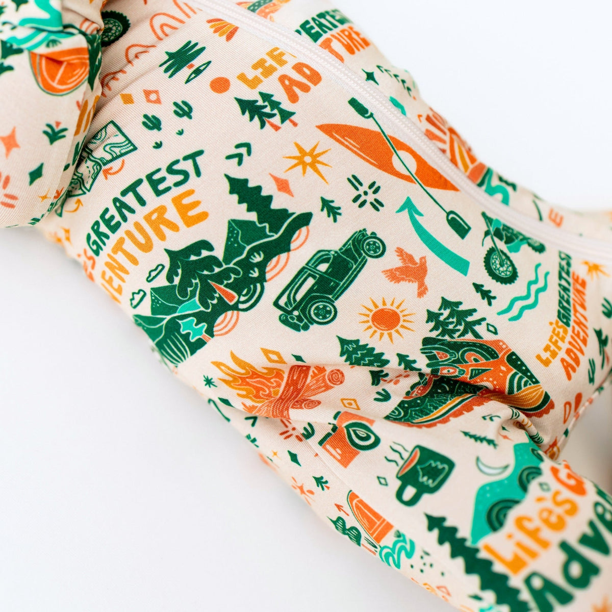 Fabric with nature-themed design featuring trees, cars, and text on a white background