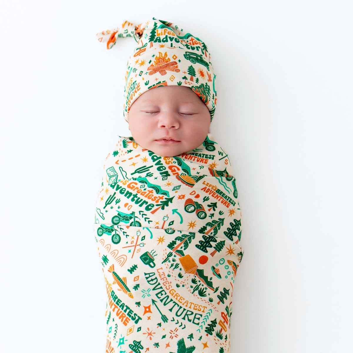 SoftKnot Cap Bamboo Newborn Cap displayed among other baby accessories, highlighting its lightweight design and matching bamboo prints.