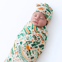 A mother nursing her baby while using The Forever Large Swaddle Blanket, emphasizing its role as a comfortable large swaddle blanket for feeding.