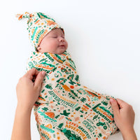 Front view of the SoftKnot Cap Bamboo Newborn Cap in Adventuresome Wanderlust, featuring a cute and cozy style for newborns.