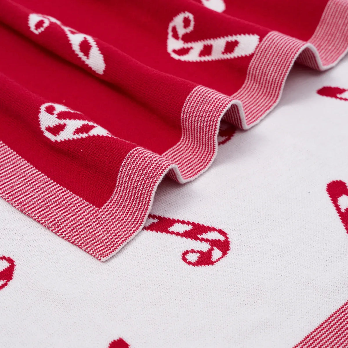 Close up of double-knit cotton texture and ribbed border contrasting red and white sides