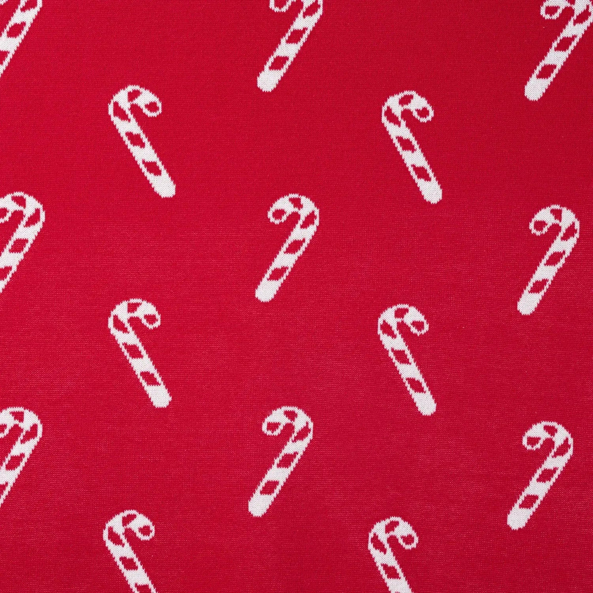 Macro shot of vibrant red fabric with white candy cane diagonal stripe pattern