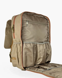 Side angle of opened diaper backpack displaying internal zippered security pocket, elastic pouches, and canvas exterior