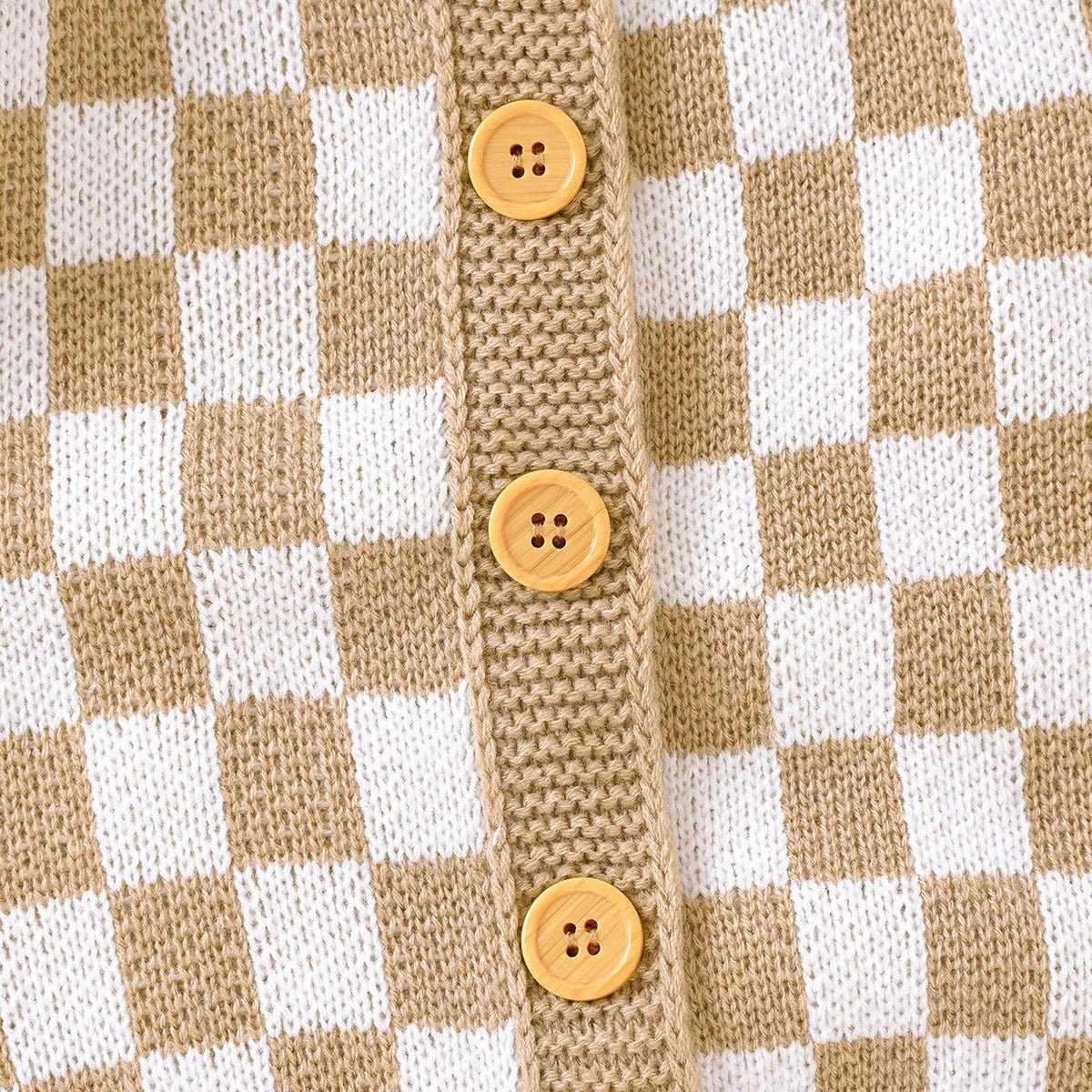 tan and white checkered baby romper with wooden buttons close-up knit fabric detail
