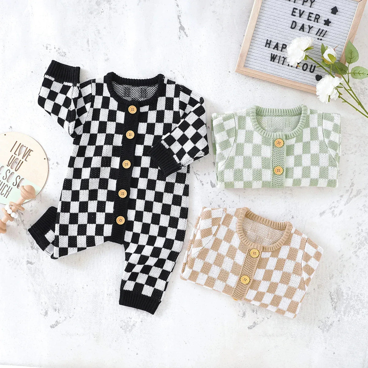 Checkered baby romper in black and white with wooden buttons for infants