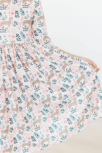 Young girl wearing Mila & Rose cheetah twirl dress for girls in soft pastel colors holding skirt out
