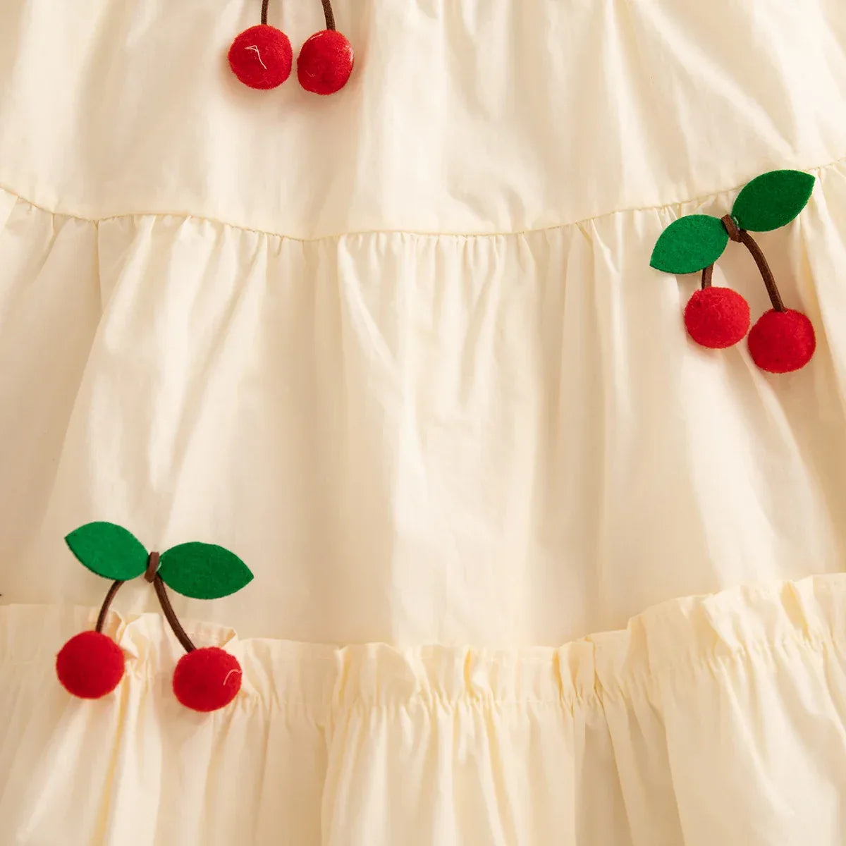 Cream baby girls cherry embroidered dress with red cherry appliques and green leaves
