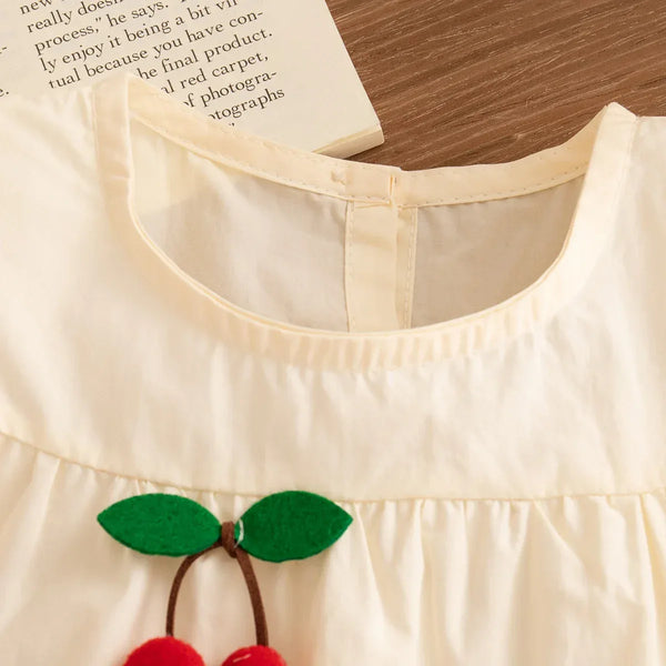 cream baby cherry embroidered dress for girls with green felt leaves and red cherries detail