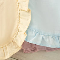 babies pastel yellow blue and mauve party dress with ruffled hem detail