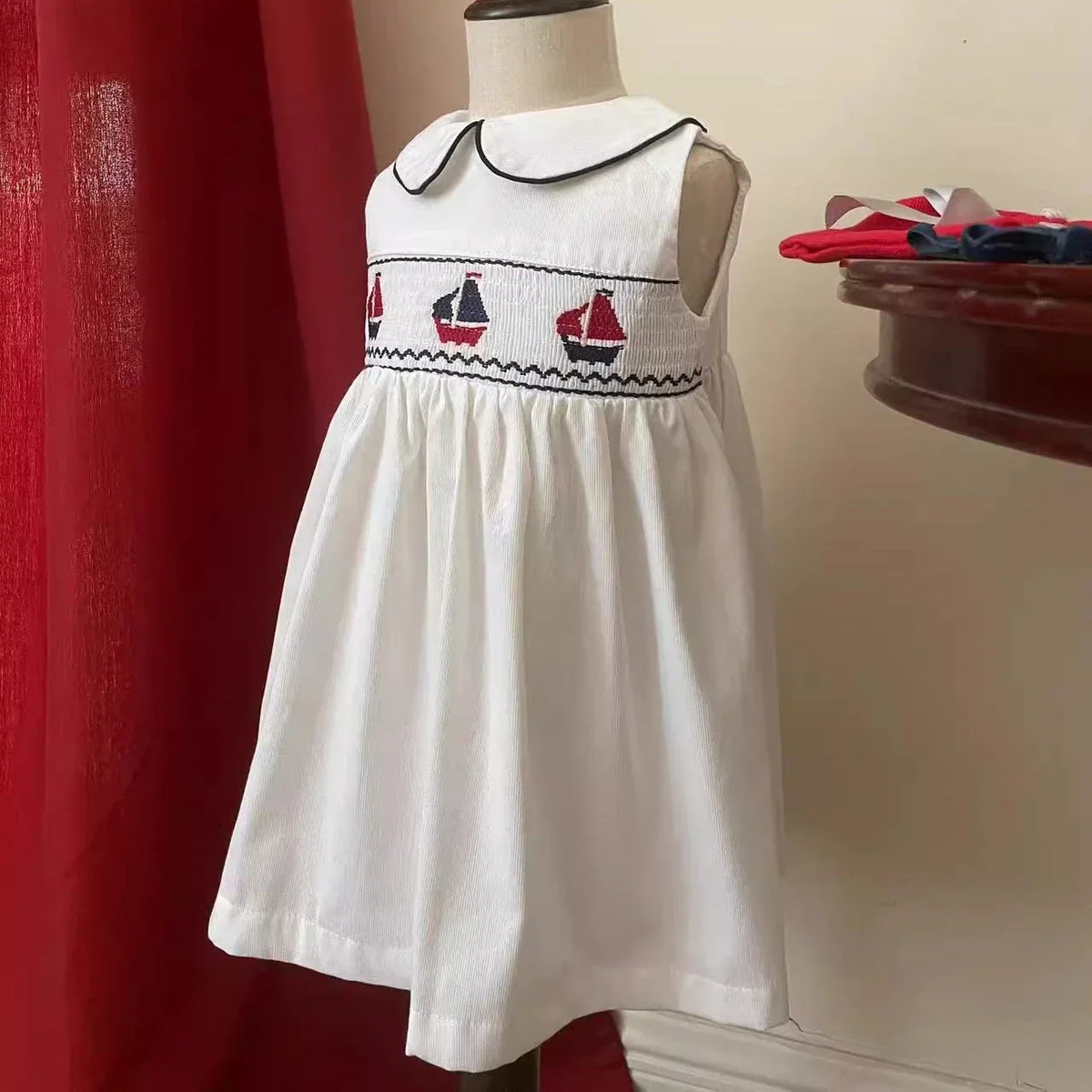 baby white sleeveless party dress with sailboat embroidery and black trim collar for toddlers