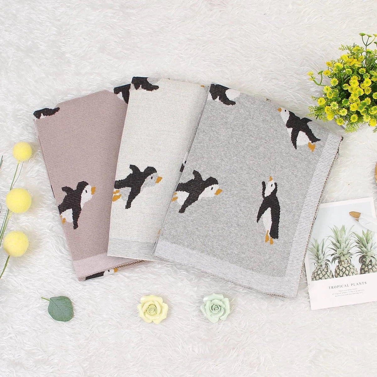 Childrens knit penguin blanket in gray, beige, and pink colors, perfect for babies and kids
