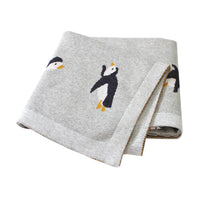 Gray childrens knit penguin blanket with black and white penguin design for babies and kids