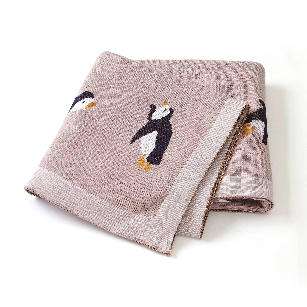 Childrens knit penguin blanket in soft pink with black and white penguin design for babies and kids