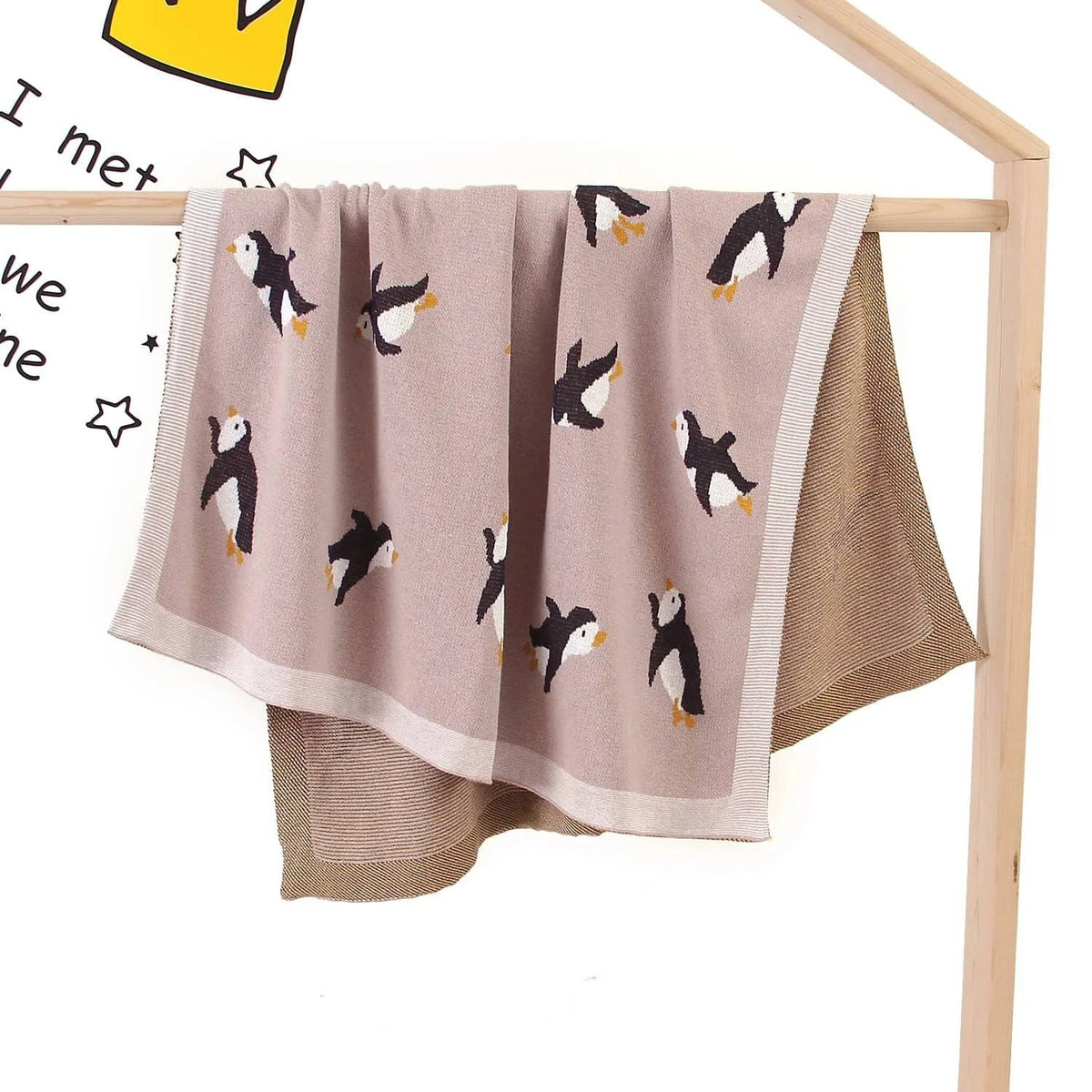 Childrens knit penguin blanket in light brown with black and white penguin designs for babies and kids