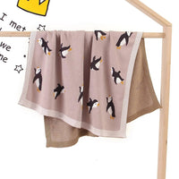 Childrens knit penguin blanket in light brown with black and white penguin designs for babies and kids