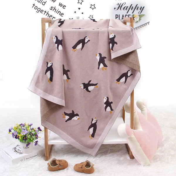 Childrens knit penguin blanket in soft pink for babies with cozy penguin pattern