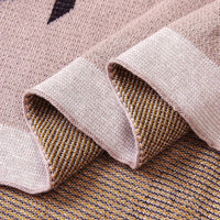 Childrens knit penguin blanket in soft beige with brown and white accents, suitable for infants and toddlers