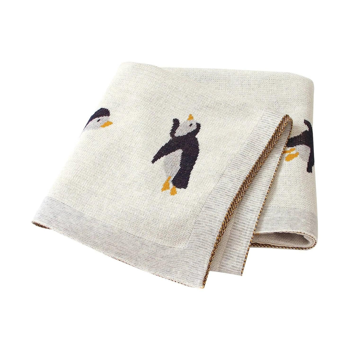 beige childrens knit penguin blanket with black and orange penguin design for babies and kids