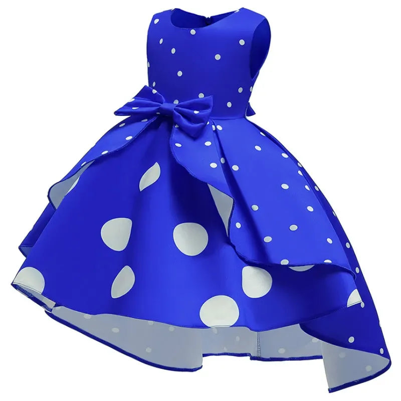 Girls royal blue childrens party dress with white polka dots and a large bow, sleeveless design
