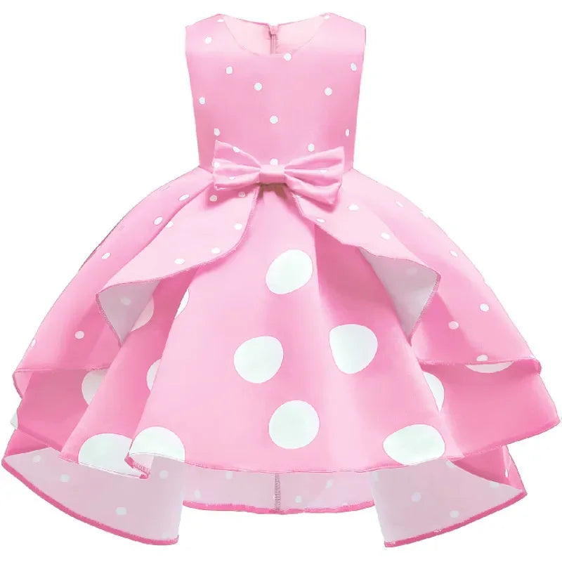 Pink girls childrens party dress with white polka dots and bow for toddlers and kids