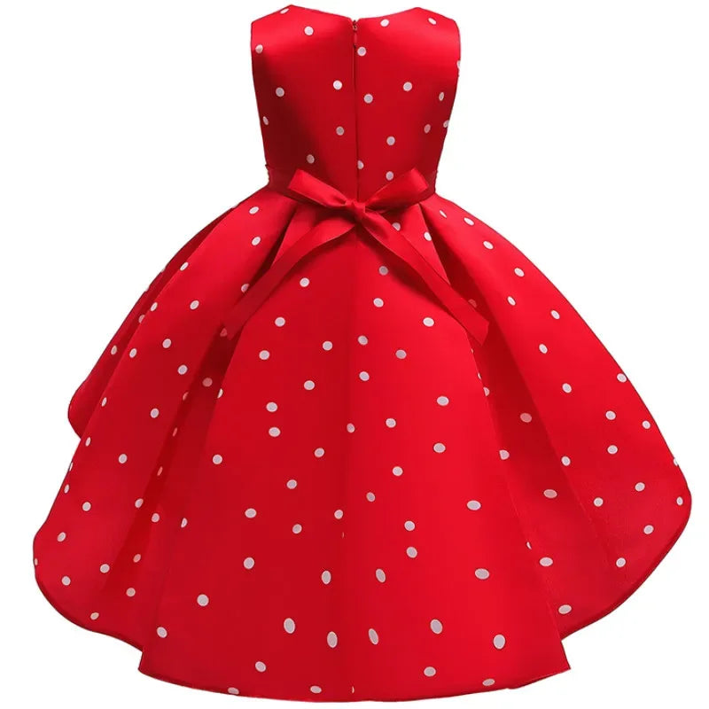 Red sleeveless childrens party dress for girls with white polka dots and a bow at the back