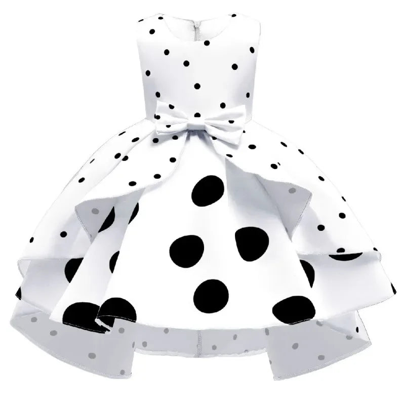 White childrens party dress for girls with black polka dots and bow detail, sleeveless