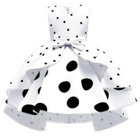 White childrens party dress for girls with black polka dots and bow detail, sleeveless