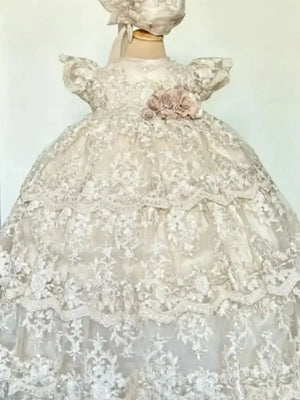 White christening long gown for babies with lace overlay and pink floral detail on waist