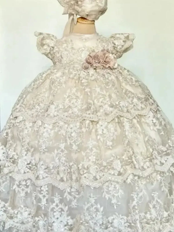 White christening long gown for babies with lace overlay and pink floral detail on waist
